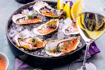 Tasty oysters on ice with lemon.
Refined with herbs and salmon caviar.