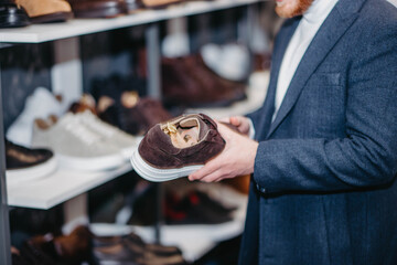 man in a store chooses shoes in a store.