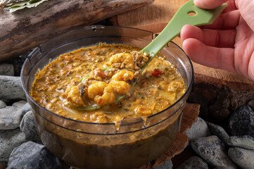 Shrimp soup with spices. Food in a transparent plate.