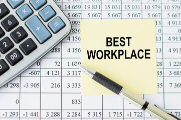 on a desk calculator, pen and note paper with text BEST WORKPLACE on the numbers background