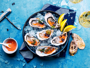 Tasty oysters on ice with lemon.
Refined with herbs and salmon caviar.