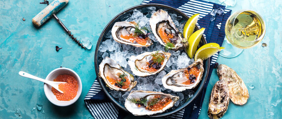 Tasty oysters on ice with lemon.
Refined with herbs and salmon caviar.
