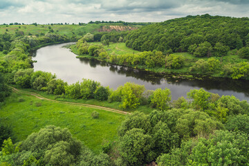 Landscape of a winding river (meandering river) in spring. View from above. Beautiful nature. Europe