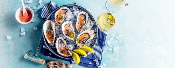 Tasty oysters on ice with lemon. Refined with herbs and salmon caviar. © karepa