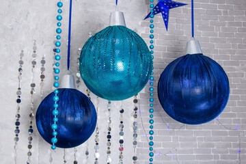 Composition from three blue christmas balls hanging on ribbon,