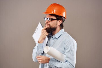 Engineer in an orange helmet shirt safety professional service beige background