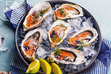 Tasty oysters on ice with lemon.
Refined with herbs and salmon caviar.