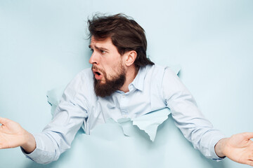 A man in a shirt peeks out from behind the wall of a career work emotions