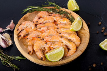 Fine selection of jumbo shrimps for dinner on stone plate.