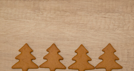 gingerbread cookies on a wooden background. Christmas tree cookies