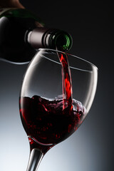Glass of red wine and bottle