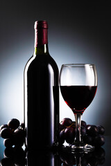 Glass of red wine and bottle