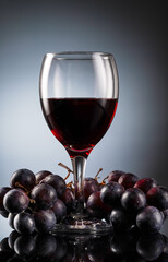 Glass of red wine and bottle