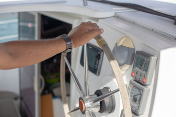 Man's Hands Steering Wheel Of Yacht. Close up