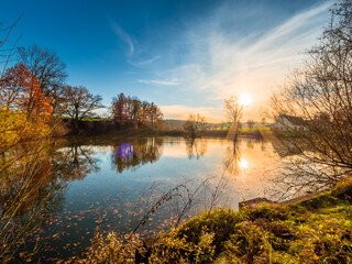 Fototapeta na wymiar Bavarian lake landscape with warm colors during sunset phase