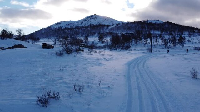 	 Cross country ski trail with snow covered mountain in the background