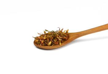 Ready for tee. Dry Hypericum flowers in a wooden spoon, Hypericum perforatum or St John's wort...