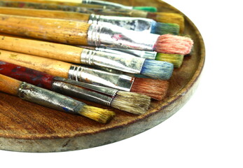 Various dirty paint brushes. Paints and brushes isolated on white background.