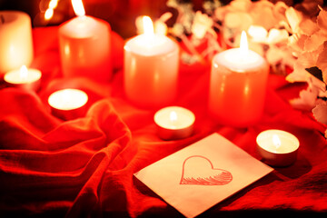 Winter Christmas or Valentine's day holidays background with candles, christmas light