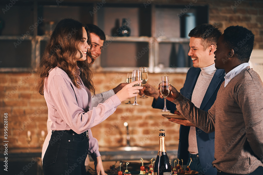 Wall mural happy friends cheering with glass of wine