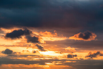 Fototapeta premium The sky is leaden with dark orange clouds at sunset.