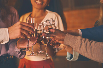 Happy friends holding the glasses of champagne and making a toast