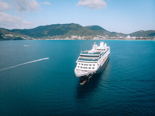 Obraz premium Large Cruise ship sailing across The Andaman sea - Aerial image. Beautiful sea landscape