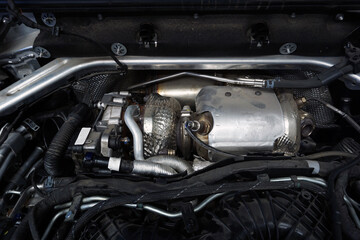 Obraz na płótnie Canvas The turbocharger is installed on the engine of a modern powerful car.