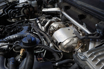 Fototapeta na wymiar The turbocharger is installed on the engine of a modern powerful car.