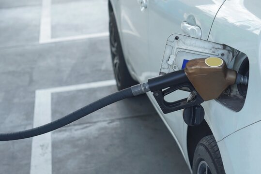 Close-UP a front veiw of the head oil dispenser was refueling in to a car oil tank.