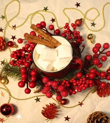 
Christmas flat lei with red berries and a cup of coffee with marshmallows