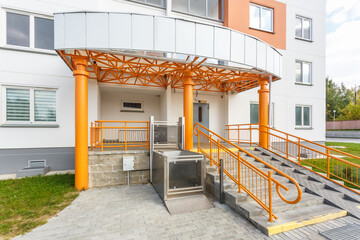 adaptation for people with disabilities, disabled people, old people, pregnant women at the entrance of a residential building. Disability stairs lift