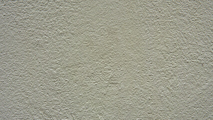 Pale yellow concrete wall. Interesting abstract background with a construction concept. Decorative textured plaster of the house wall. Outside surface finish at home.