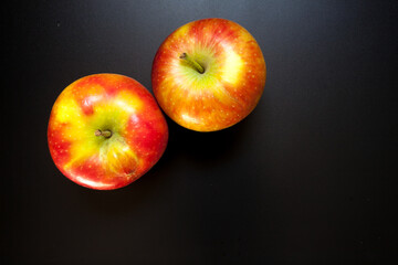 Apples on black table, food background