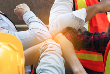 Team of Engineers wear reflective vest and safety helmet giving elbow greeting to avoid the spread of coronavirus (COVID-19). Greeting with bump elbows instead. Teamwork and social distance concept.
