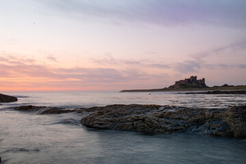 Obraz premium Sunrise on medieval castle at beach 