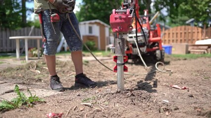Technician installing foundation helical piles