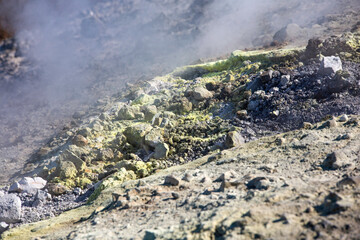 Sulfur haze and its crystals on the lava rocks. Volcano Island in the archipelago of Aeolian...