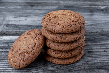 Freshly baked stack of oatmeal cookies on an old, vintage, wooden background. Close-up.