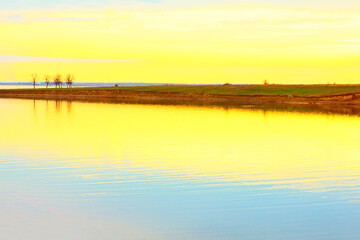 Dawn in yellow tone . Lake scenery in the morning