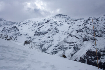 Fototapeta na wymiar Steep rocks in Pais Chile Snow Valley covered in soft white snow with Christmas atmosphere