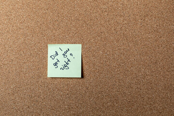 green sticker on brown table. color sticker, motivational, quote and words, note, message