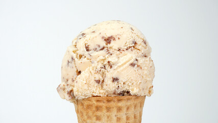 Ice cream flavor Chocolate Chip scoop in waffle cone on white background, Closeup Front view Food concept.