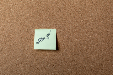 green sticker on brown table. color sticker, motivational, quote and words, note, message