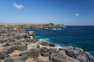 Fototapeta na wymiar Beautiful landscape of the shoreline on the Galapagos Islands with lava rocks, steep cliffs and deep blue pacific ocean, Ecuador, South America
