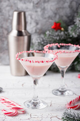 Pink peppermint martini with candy cane rim
