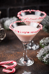 Pink peppermint martini with candy cane rim