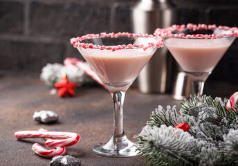 Pink peppermint martini with candy cane rim