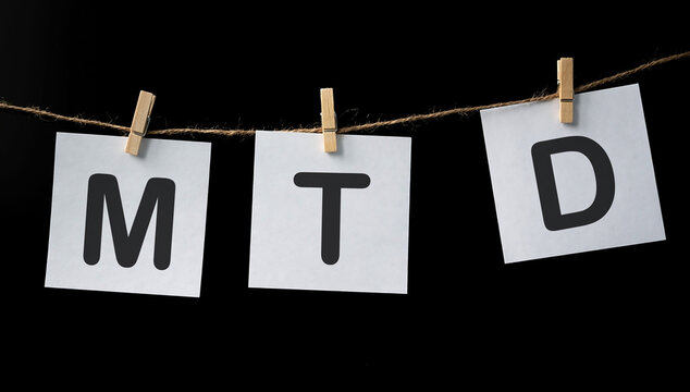 MTD - Month To Date acronym on white stickers, business concept background