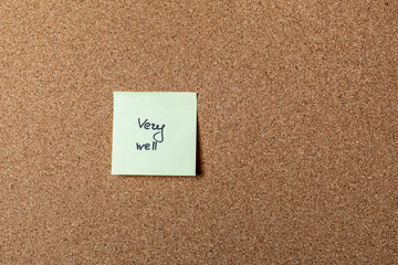 green sticker on brown table. color sticker, motivational, quote, and words, note, message very well